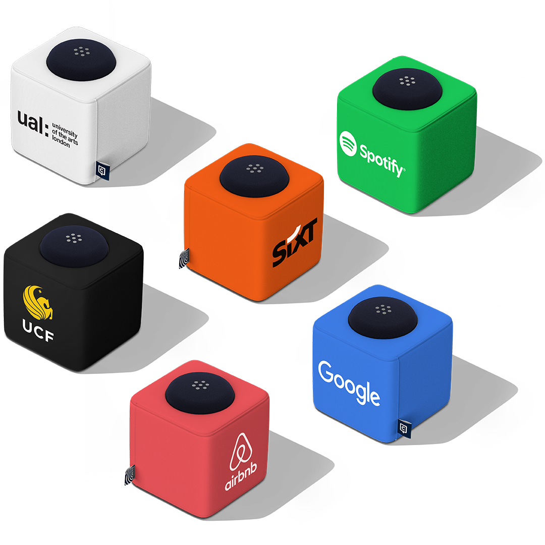A showcase of customized Catchbox Cube microphones with branded covers from various organizations, including University of the Arts London, Spotify, UCF, Sixt, Google, and Airbnb, each displaying unique colors and logos.