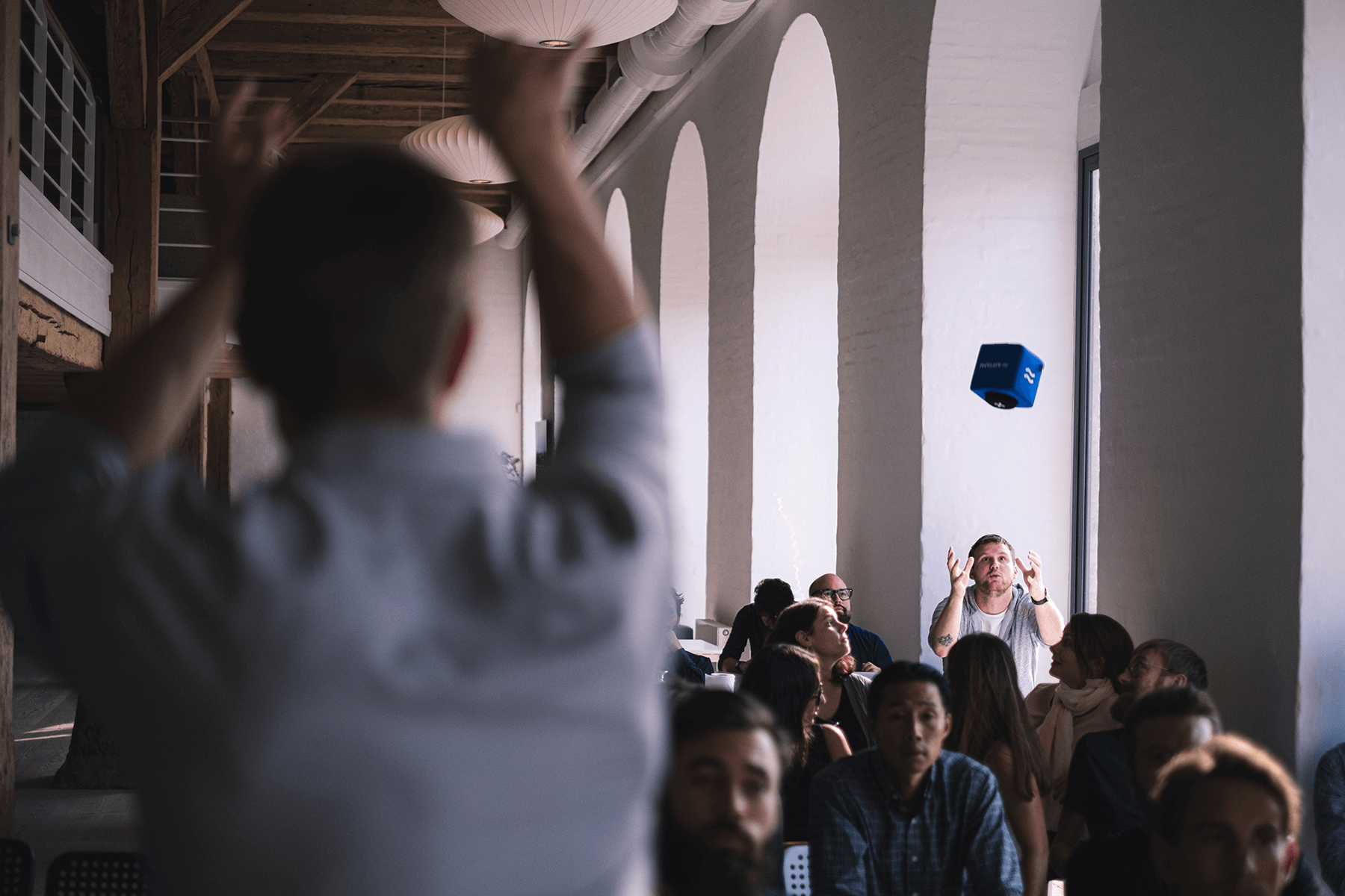 Customized Catchbox Cube microphone being tossed into the audience during an interactive session.