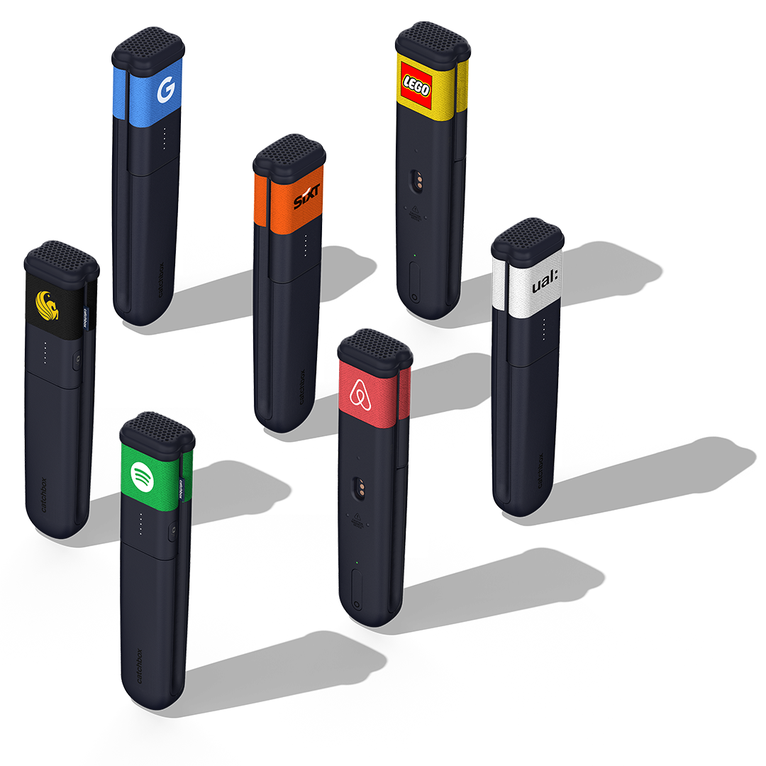 Collection of Catchbox handheld microphones with customized Stick Jackets featuring logos and colors from various brands.