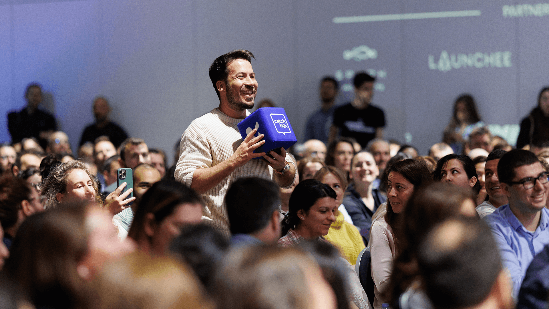 Participant at a conference using the Catchbox Cube throwable mic virtual collaboration tool